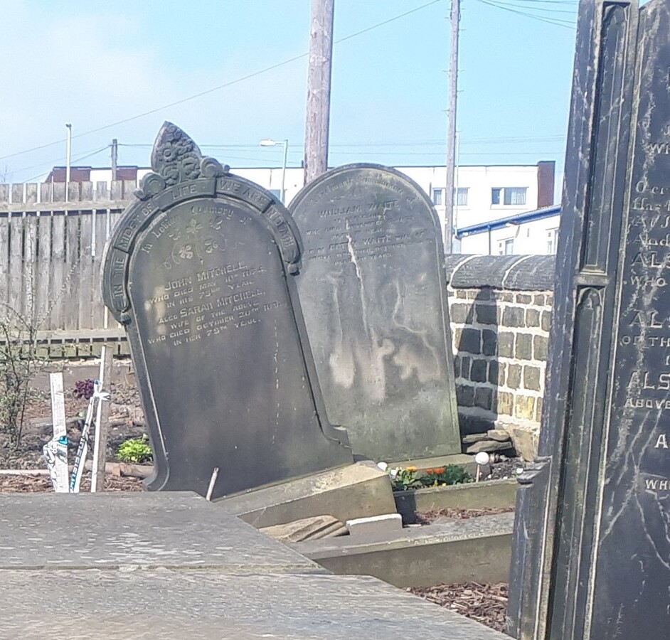 Badly leaning John Mitchell headstone